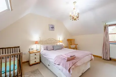 a bedroom with a bed and a crib at 3 Bed in Dolgellau oc-24459 in Bont Newydd