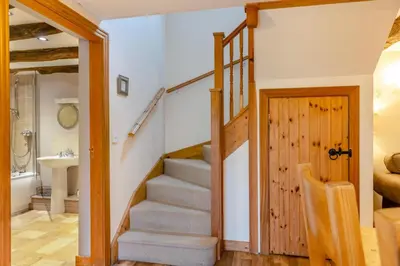 a staircase in a house with a bathroom and a sink at 3 Bed in Dolgellau oc-24459 in Bont Newydd