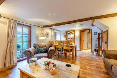 a living room with a couch and a table at 3 Bed in Dolgellau oc-24459 in Bont Newydd