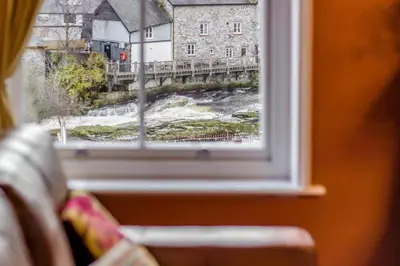 a window with a view of a river and a bridge at 5 Bed in Llangollen oc-l34205 in Llangollen