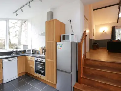 a kitchen with a refrigerator and a microwave at The Old Sunday School in Brecon