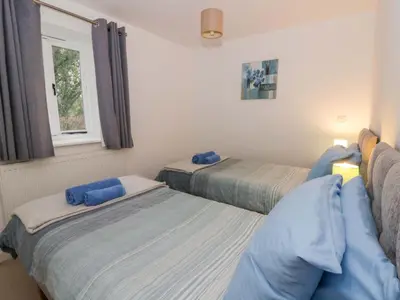 a bedroom with two beds and a window at The Old Sunday School in Brecon