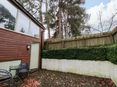 a backyard with a fence and a table and chairs at The Old Sunday School in Brecon