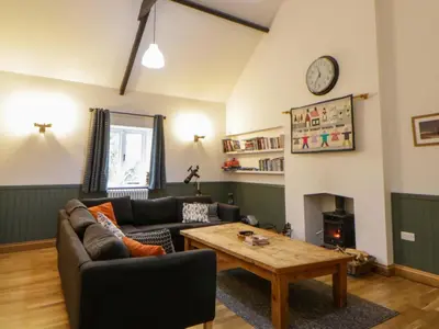 a living room with a couch and a table at The Old Sunday School in Brecon