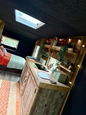 a bedroom with a desk and a bed and a mirror at Nesta's Nook in Llandovery