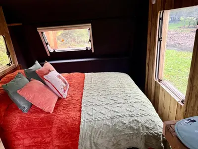 a bedroom with a bed with pillows and a window at Nesta's Nook in Llandovery