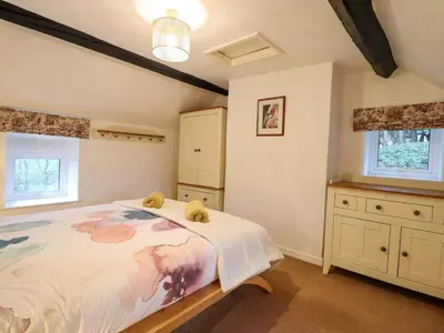 a bedroom with a bed with two teddy bears on it at Bryn Y Garreg Cottage - The Wireless Tech Free Farm in Llangadfan