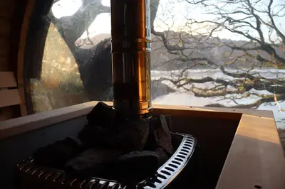 a bottle sitting on top of a basket in a window at Salt Marsh Cabin - Hot tub-Sauna in Barmouth