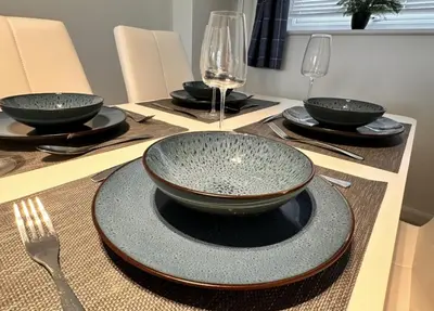 a table with four bowls and a plate on it at Pet friendly 3 bed retreat for beach, castle, golf in Harlech