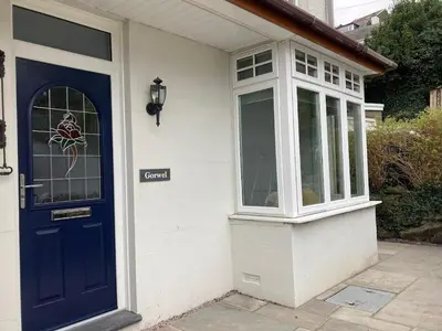 a house with a blue door and a window at Harlech castle and beach home in Harlech