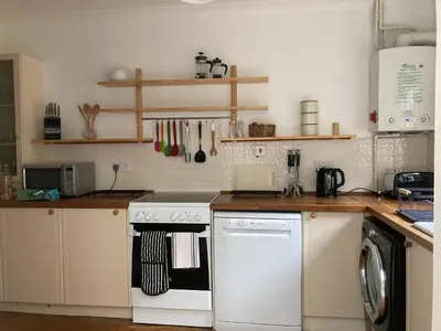 a kitchen with a white stove and a dishwasher at Harlech castle and beach home in Harlech