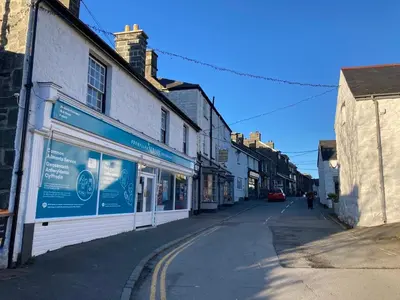 an empty street in a town with buildings at Harlech castle and beach home in Harlech