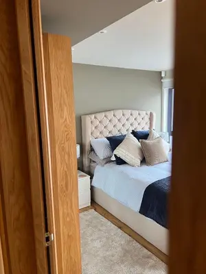 a bedroom with a bed with pillows on it at Y Llofft in New Quay