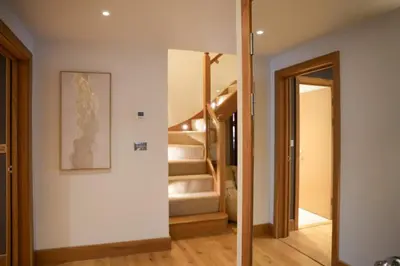 a hallway with stairs in a house at Y Llofft in New Quay