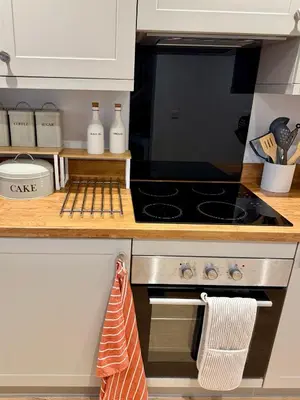 a kitchen counter with a stove top oven at Unique Vicarage Town Cottage in Leominster