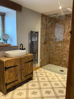 a bathroom with a sink and a shower at Y Beudy Bach in Llanfor