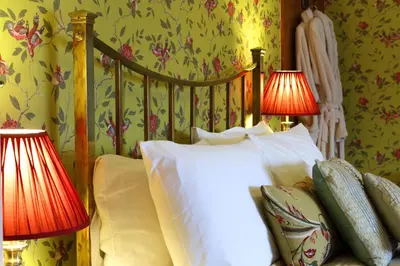 a bedroom with a bed with two lamps on it at Victoria House in Church Stretton
