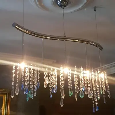 a chandelier with crystals hanging from a ceiling at Victoria House in Church Stretton