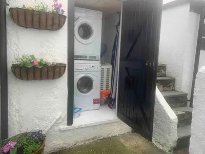 a washing machine and a washer and dryer in a house at Pandy Cottage in Aberdyfi