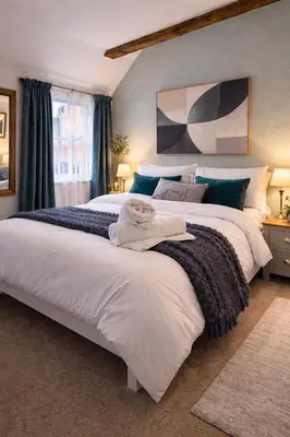 a bedroom with two beds with towels on them at Cosy Town centre Historic Tudor Cottage & parking sleeps 6 in Shrewsbury