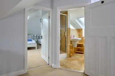 a room with a bathroom with a sink and a mirror at Finest Retreats - Bryn Awelon in Harlech