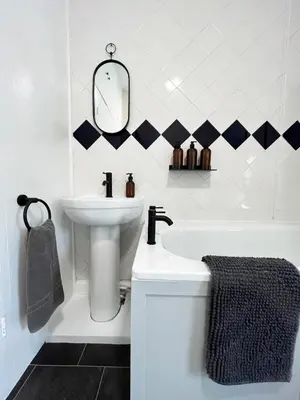 a white bathroom with a sink and a mirror at Arenig Cottage, a Snowdonia retreat near Lake Bala in Bala