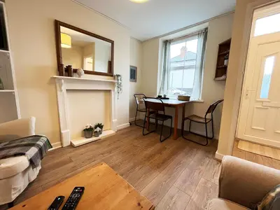 a living room with a table and a dining room at Arenig Cottage, a Snowdonia retreat near Lake Bala in Bala