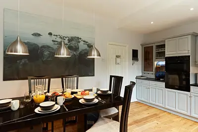 a kitchen with a dining room table with chairs at Ever popular 2 bedroom riverside home - to sleep 4 - Pass the Keys in Shrewsbury
