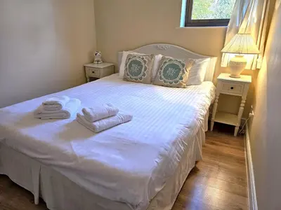 a bedroom with a white bed with towels on it at Ever popular 2 bedroom riverside home - to sleep 4 - Pass the Keys in Shrewsbury