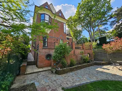 an exterior view of a brick house with a fence at Ever popular 2 bedroom riverside home - to sleep 4 - Pass the Keys in Shrewsbury