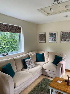 a living room with a couch and a window at Rosehill annexe in Knighton