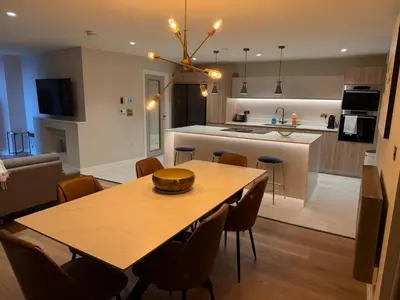 a dining room and kitchen with a table and chairs at 3 Bed Spacious Luxury Duplex - Shrewsbury Town Centre in Shrewsbury