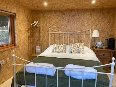 a bedroom with a large bed in a room at Bijou Cabin in Ludlow