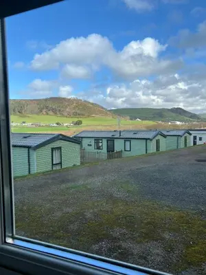 a view of a group of buildings from a window at Welsh Coast Seaview 2 Bedroom Wooden Lodge at Clarach Bay in Aberystwyth