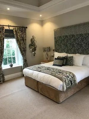 a bedroom with a large bed and a window at Foyles of Glasbury in Glasbury