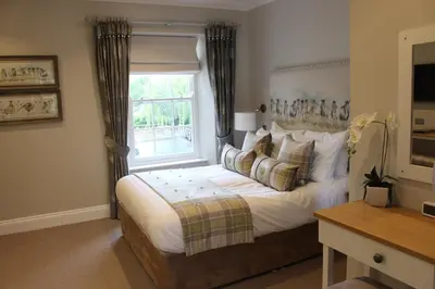 a bedroom with a large bed with a window at Foyles of Glasbury in Glasbury