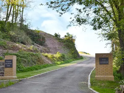 an empty road with signs on the side of a hill at Sea View in Rhyd-y-felin