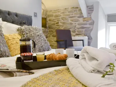 a hotel room with a bed with a tray of food at Ivy Bush Cottage in Llanddewi-Brefi