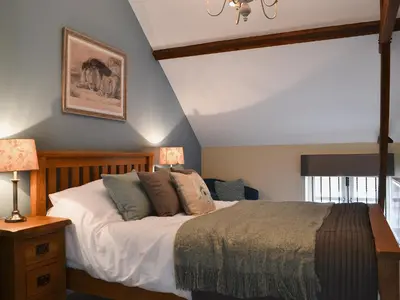 a bedroom with a bed and two lamps and a window at Red Lion Lodge in Myddle