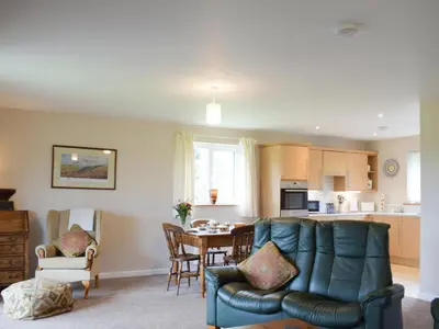 a living room with a couch and a table at The Lodge in Presteigne