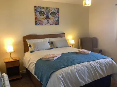 a bedroom with a bed with two towels on it at The Lodge in Presteigne