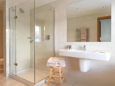 a bathroom with a sink and a glass shower at Y Talbot in Tregaron
