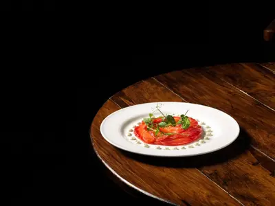 a white plate of food on a wooden table at Y Talbot in Tregaron