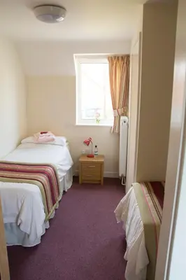 a small room with two beds and a window at Ludlow Mascall Centre in Ludlow