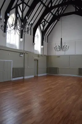 a large room with a wooden floor and a chandelier at Ludlow Mascall Centre in Ludlow