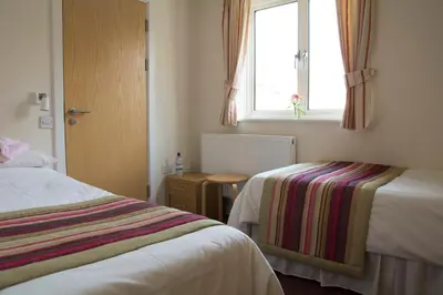 a hotel room with two beds and a window at Ludlow Mascall Centre in Ludlow