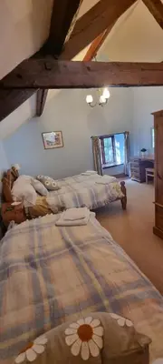 a bedroom with two beds in a room at Brynderwen Barn in Llangorse