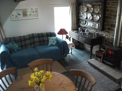 a living room with a couch and a table at Swallow Barn in Llanwrtyd Wells