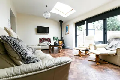 a living room with a couch and chairs and a tv at Shrewsbury Cottage in Shrewsbury