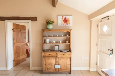 a room with a wooden cabinet and a door at Gaer Fawr Barns in Guilsfield